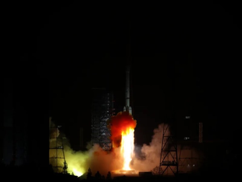 Nighttime rocket launch of China's TJS-14 satellite aboard a Long March 3B vehicle from Xichang Satellite Launch Center, with bright flames and smoke illuminating the dark sky, January 23, 2025.