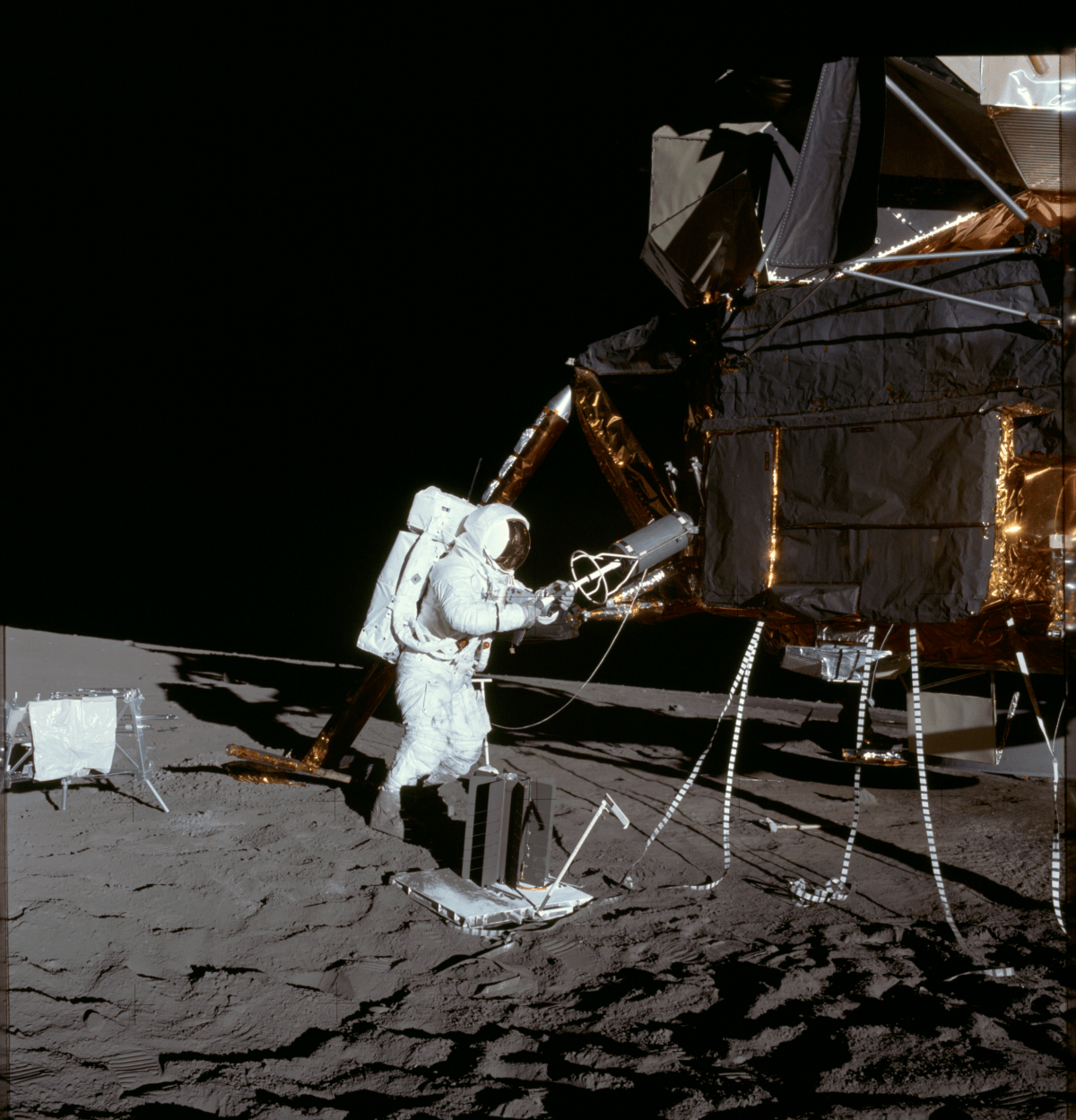 Apollo 12 astronaut Alan Bean extracts the fuel element of a Radioisotope Thermoelectric Generator (RTG) from storage on the lunar module on the Moon. Credit: NASA